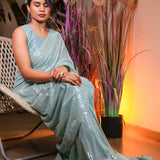 Mint green sequin saree with readymade sequin blouse.